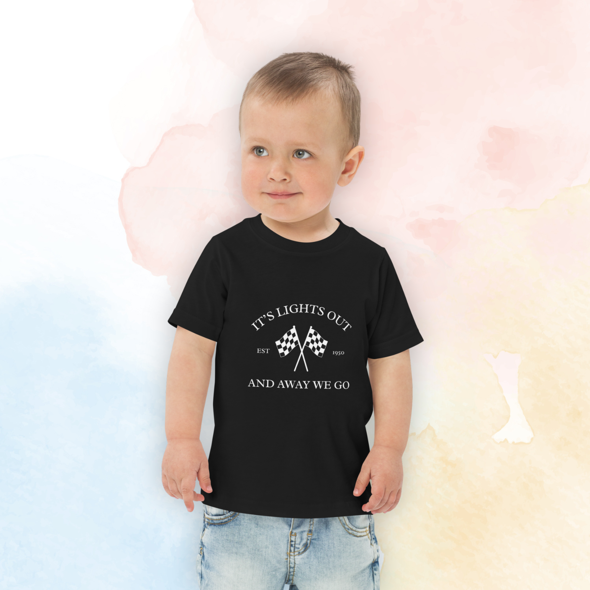 Toddler racing t-shirt featuring “It’s Lights Out and Away We Go” with checkered flags. Soft printed kids motorsport tee for little race fans.