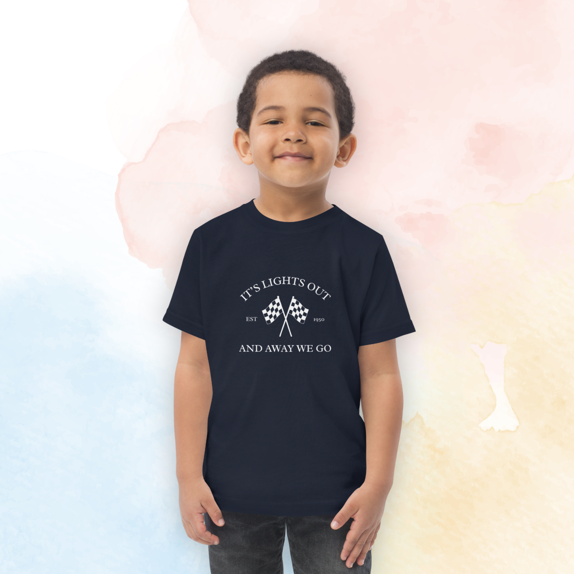 Toddler racing t-shirt featuring “It’s Lights Out and Away We Go” with checkered flags. Soft printed kids motorsport tee for little race fans.