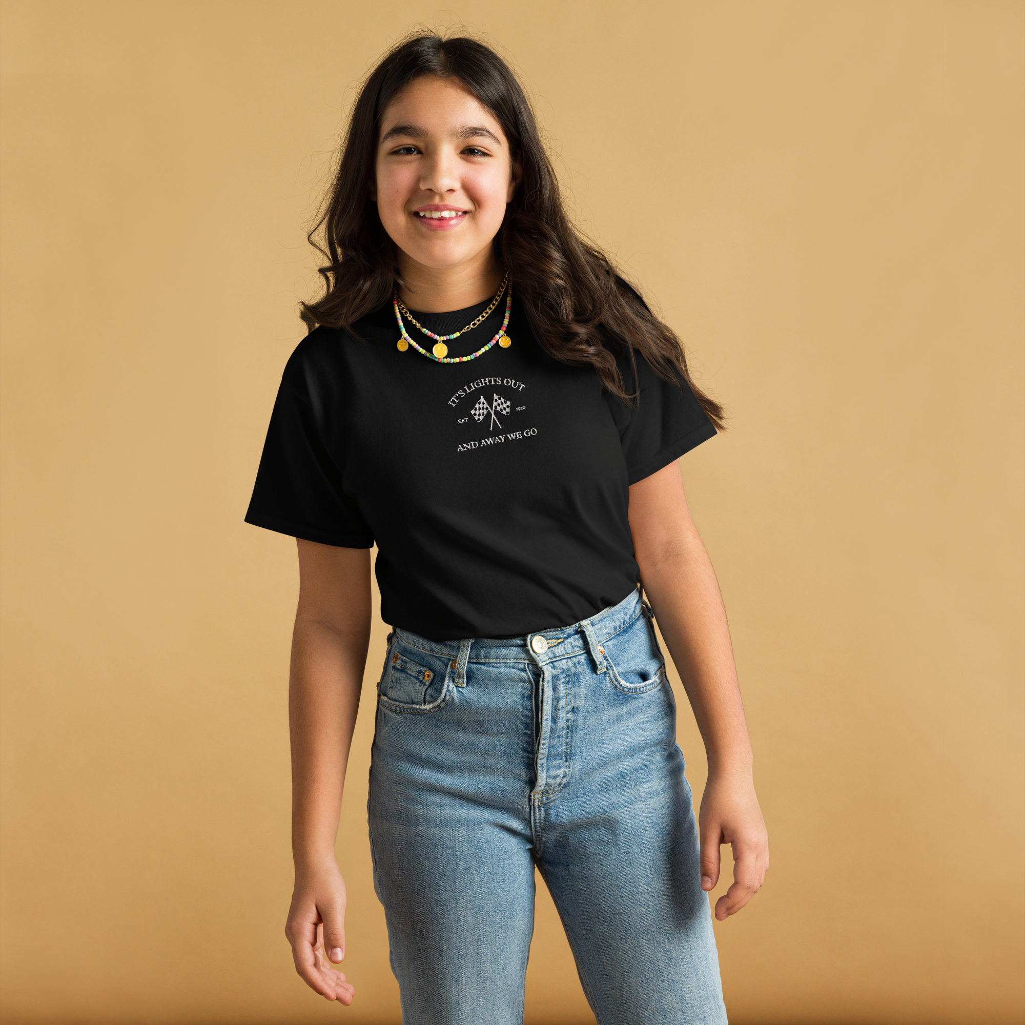 Kids racing t-shirt featuring “It’s Lights Out and Away We Go” with checkered flags. Soft cotton youth motorsport tee for young race fans.